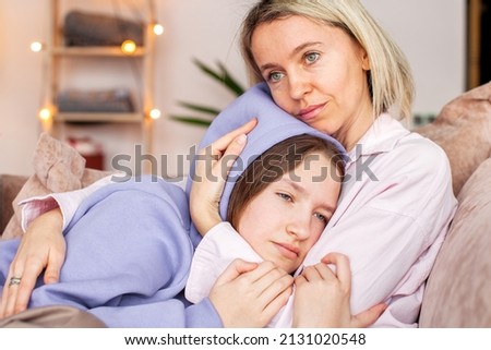 Caring Caucasian mother talk comfort unhappy sad teenage daughter suffering from school bullying or psychological problems, loving mom support make peace with depressed introvert teen girl child Royalty-Free Stock Photo #2131020548