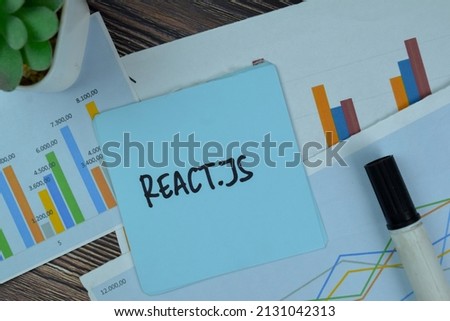 React.JS write on sticky notes isolated on Wooden Table. Royalty-Free Stock Photo #2131042313