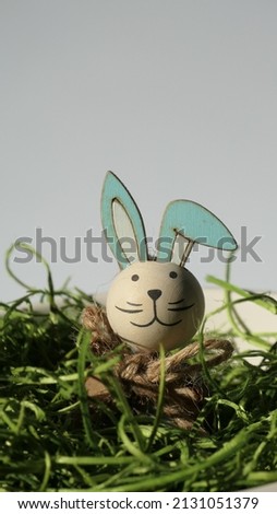 cheerful easter bunny sticking out its head from green grass easter nest isolated