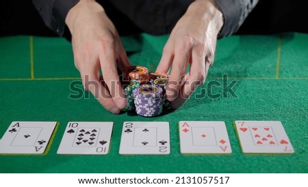 Gamer person playing poker in casino. Betting chips stacks. Call and raise. Card game on green table. Gambling. Texas Hold'em. Dealer and gambler, fortune. Royalty-Free Stock Photo #2131057517