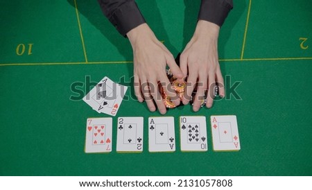 Gamer person playing poker in casino. Betting chips stacks. Call and raise. Card game on green table. Gambling. Texas Hold'em. Dealer and gambler, fortune. Royalty-Free Stock Photo #2131057808