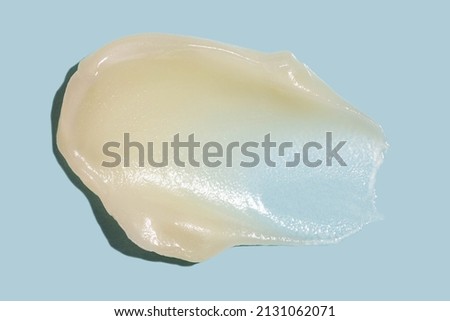 Hydrophilic oil based cleanser cleansing balm swatch. Gentle makeup removing cream isolated on blue background. Soft focus. Royalty-Free Stock Photo #2131062071