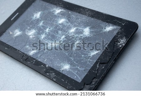 Broken glass on an electronic gadget. Repair and replacement of glasses on the phone.