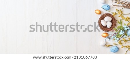 Willow branches and decorations, easter eggs on a light background. Happy easter flat lay concept  Royalty-Free Stock Photo #2131067783