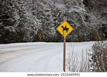 Yellow Caution Horse Riding Sign in a Rural Setting in Winter