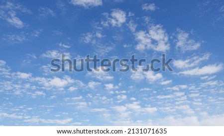 Puffy white clouds and blue sky suitable for background or sky subsitution Royalty-Free Stock Photo #2131071635