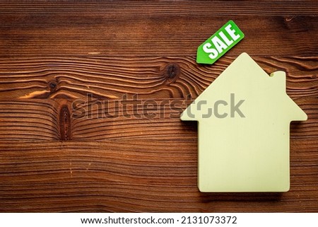 House for sale concept. Sale label with wooden house model