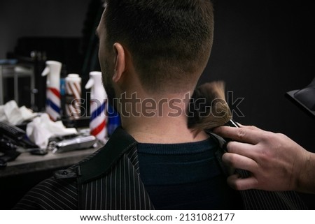  a man gets a haircut in a barbershop Royalty-Free Stock Photo #2131082177