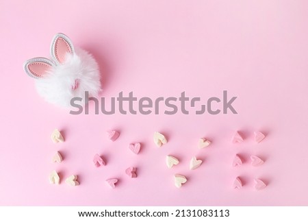 Postcard with word love from marshmallow and toys hare on a pink background, happy birthday greetings, Valentines day