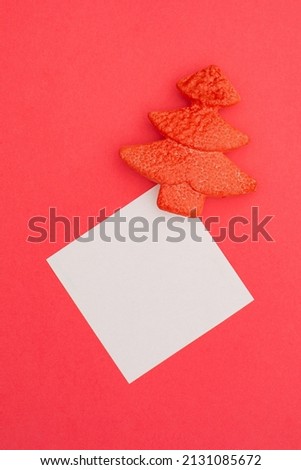 Christmas Square leaflet mock up blank template design idea. A melting red Christmas tree mockup against pastel pink background. Copy space templates designs for new year message layout. Noel.