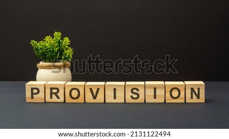 letters of the alphabet of PRIVILEGE on wooden cubes, dark surface. green plant. black background