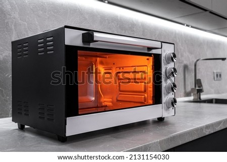 Electric mini oven for homemade cooking Royalty-Free Stock Photo #2131154030
