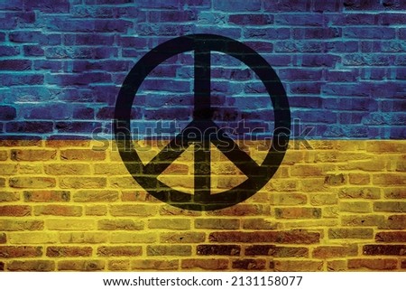 Ukraine flag on wall and peace symbol. Ukraine war concept