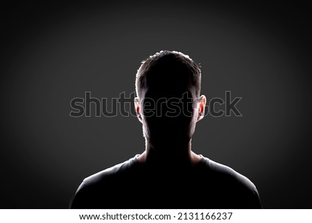 dark backlight shadow silhouette of male person, incognito unknown profile Royalty-Free Stock Photo #2131166237