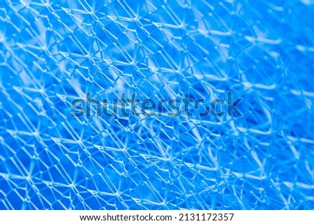 background texture Closeup of blue netting. Abstract background with intersection of nylon threads at high magnification.