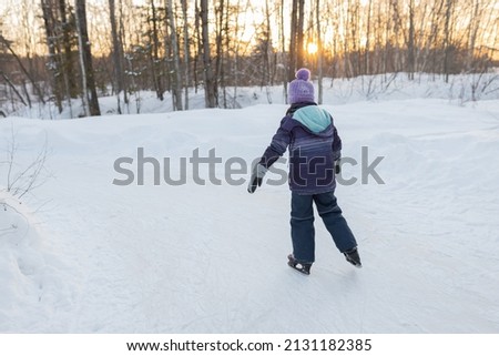 Winter fun outdoor ice skating little girl sunset 
