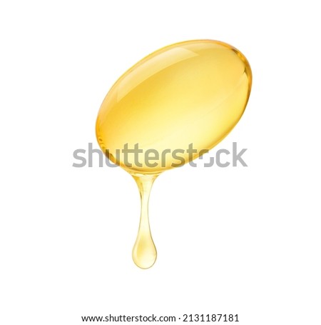 Oil dripping from soft gel capsule isolated on white background.