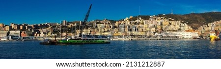 Image of old port of Genova city with cargo boats with crane at quay, Italy.