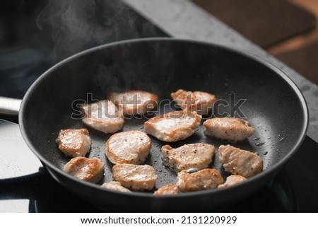 fying chicken fillet slices on nonstick pan Royalty-Free Stock Photo #2131220929
