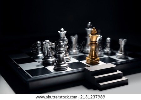 Golden king chess surrounded by enemy and checkmate for end game, But he has emergency exit stairs prepare for worst case scenario. Business strategy and life planning concept. Royalty-Free Stock Photo #2131237989