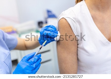 Covid-19 Vaccination. Patient Getting Vaccinated Against Coronavirus Receiving Covid Vaccine Intramuscular Injection During Doctor's Appointment In Hospital. Corona Virus Immunization