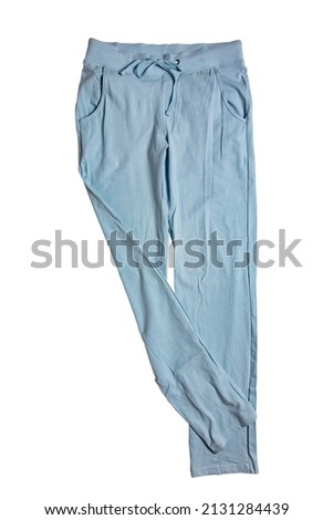 Sweat pants isolated. Close-up of womans fashionable blue casual trousers or jersey trousers isolated on a white background. Jogging outfit for workout. Clipping path.