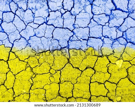 Ukraine flag with cracked ground texture. Stop the war and peace in Ukraine concept