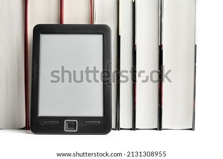 E-book and a row of paper books close-up.