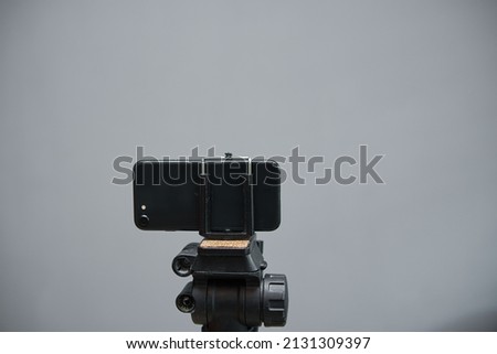 modern smartphone mounted on the tripod. creating high quality photos and videos using smartphone