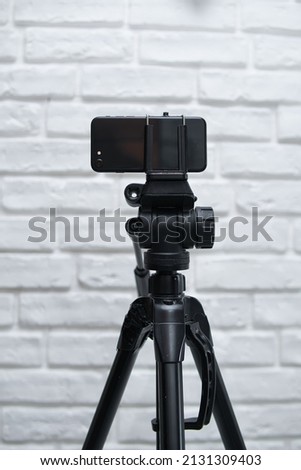 modern smartphone mounted on the tripod. creating high quality photos and videos using smartphone