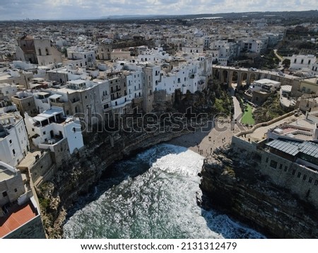 Aerial view of Polignano a Mare, a village built on the edge of the sandstone cliffs above the Adriatic Sea in Apulia, Italy. Drone photography of Lama Monachile bay.