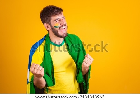 Brazilian man, latin american, cheering for brazil, in the world cup 2022, fan, brunette, celebrating, vibrating, happy screaming goal, handsome. Royalty-Free Stock Photo #2131313963