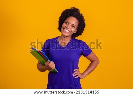 student woman smiling looking at camera with space for text on yellow background. Mature black student woman