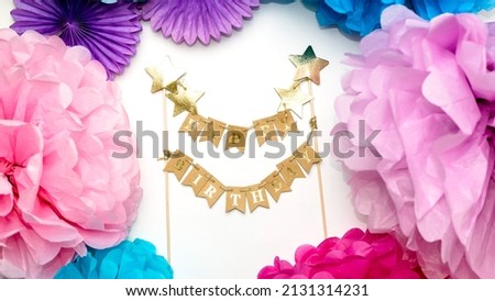 Multi-colored paper decorations and the inscription HAPPY BIRTHDAY. Happy birthday card