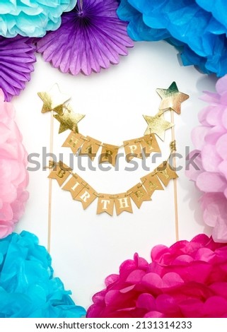 Multi-colored paper decorations and the inscription HAPPY BIRTHDAY. Happy birthday card