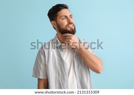 Stylish bearded man on blue background