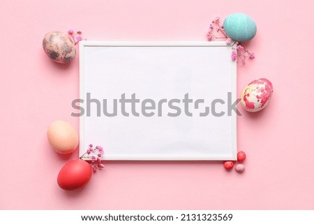 Easter composition with blank photo frame on pink background