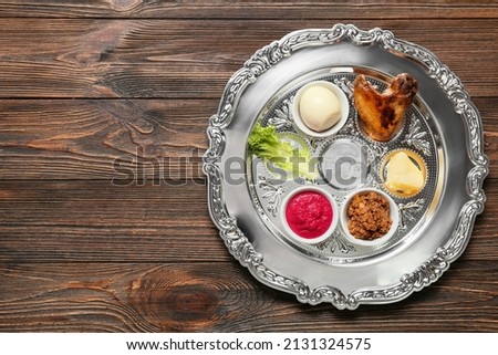 Passover Seder plate with traditional food  on wooden background