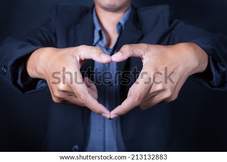 Business man make heart shape with his hand