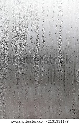 Water condensation on window glass background. Outside , bad weather, rain, humidity and foggy blank. Vertical natural background