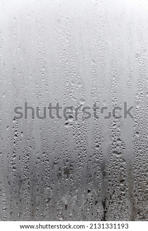 Water condensation on window glass background. Outside , bad weather, rain, humidity and foggy blank. Vertical natural background Royalty-Free Stock Photo #2131331193