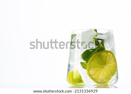 Fresh and cold Mojito cocktail on white background.