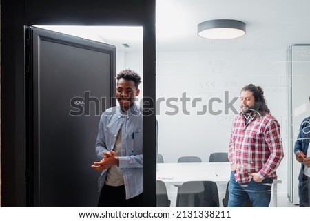 multiracial group of office workers leaving a meeting room. people at work. Royalty-Free Stock Photo #2131338211