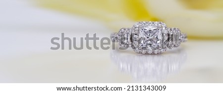 diamond engagement ring on yellow abstract color background