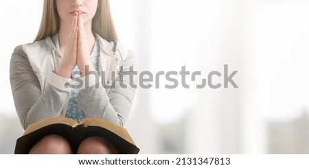 Woan praying on holy bible. Worship Faith and Read Bible Online at home.