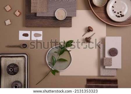 Flat lay of creative architect moodboard composition with samples of textile, paint, panels and tiles. Natural materials. Beige and brown color palette. Top view. Copy space. Template.