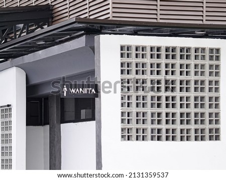 Public toilet entrance with "wanita" signage which means ladies or women.