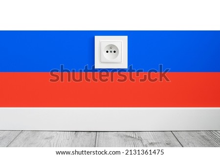 Electrical socket isolated on Russian Federation flag. Sanctions on russia background. Russian flag backdrop. Electricity price crisis. 