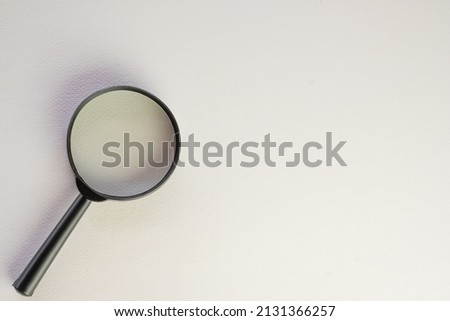 Search,Creative,focus concept.,Top view Magnifying glass on  bottom left corner over white background with copyspace for put text or logo.,Flat lay photo.