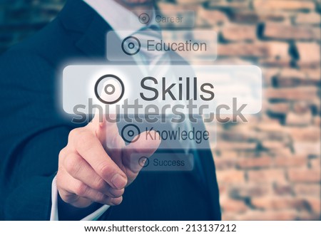 Businessman pressing a Skills concept button. Instagram Styling Applied. Royalty-Free Stock Photo #213137212